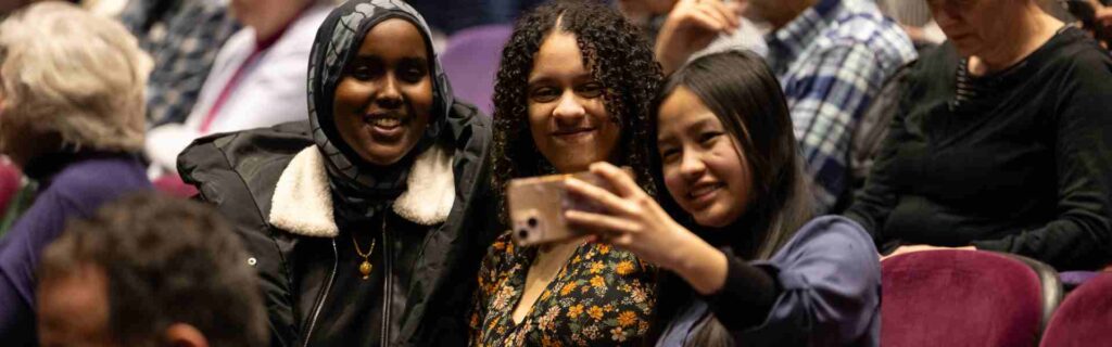 Three St. Kate's students taking a selfie in the house